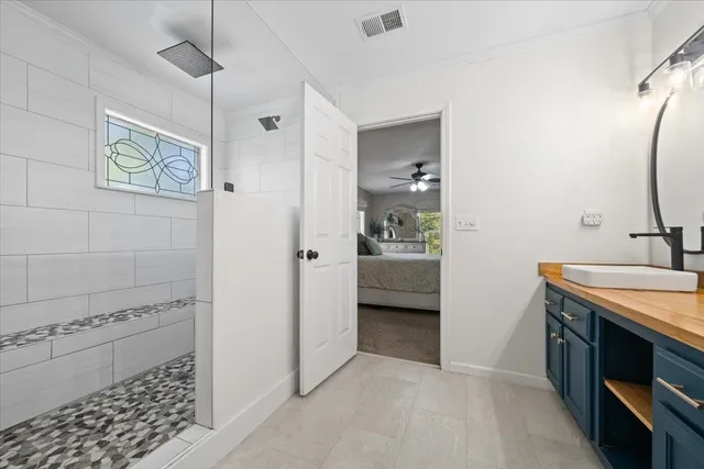 a en suite bathroom with a sink and a mirror