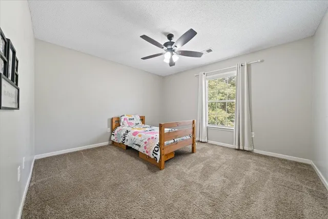 a bed room with a bed and a chandelier