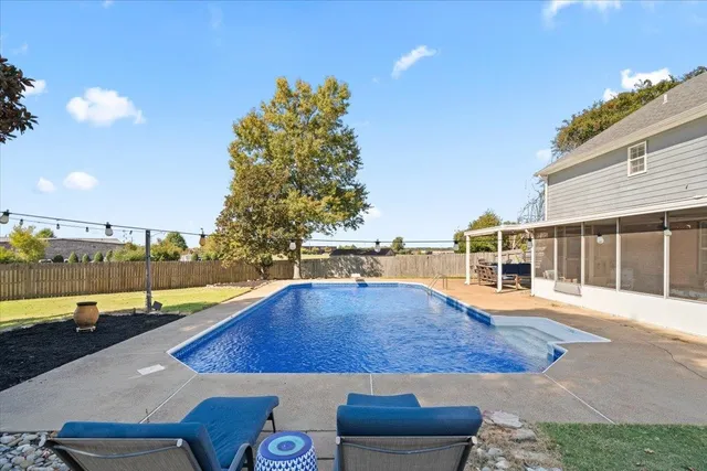 a view of a swimming pool with an outdoor seating
