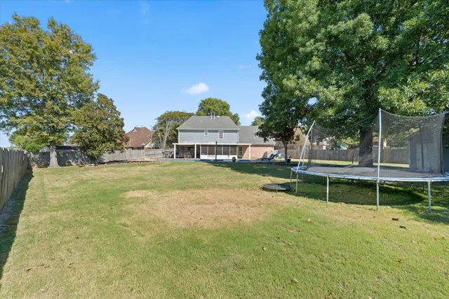 a view of house with a yard