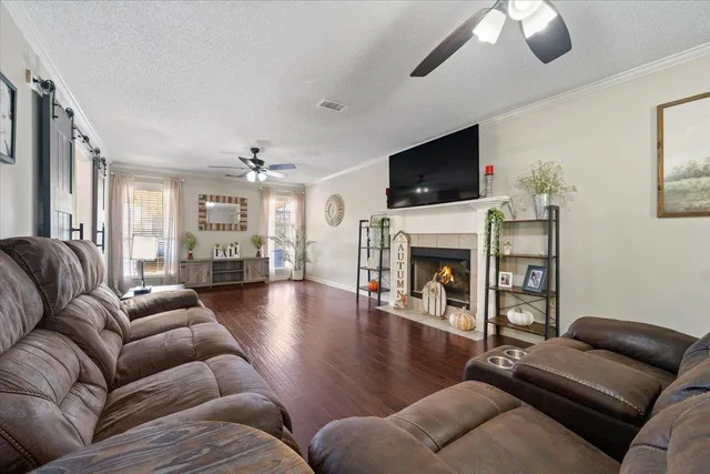 a living room with furniture a flat screen tv and a fireplace