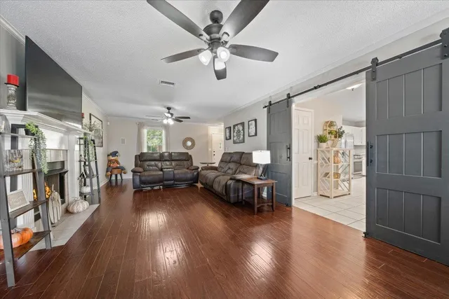 a living room with furniture and a wooden floor