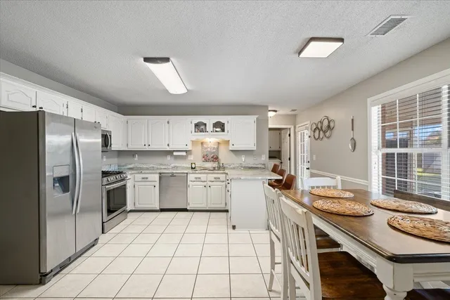a kitchen with a sink appliances and cabinets