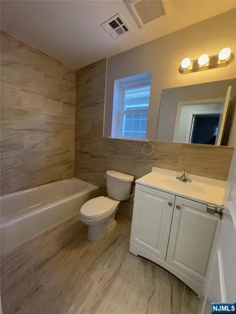 a bathroom with a sink a toilet and bathtub