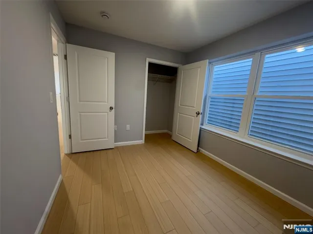 a view of hallway with wooden floor