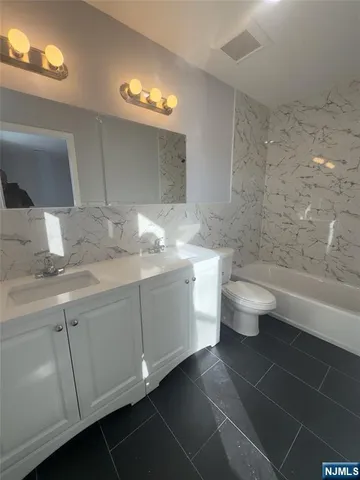 a bathroom with a sink toilet a shower and bathtub
