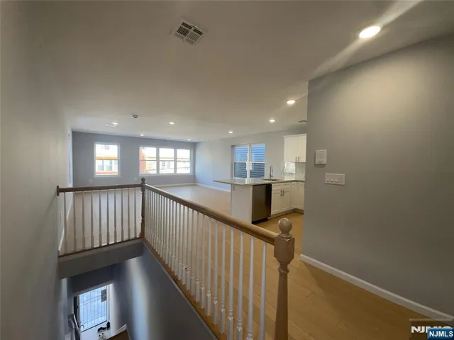 a kitchen with stainless steel appliances granite countertop a sink stove refrigerator and cabinets