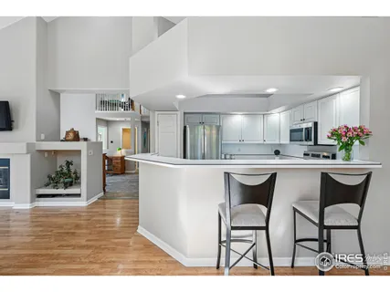 a bedroom with a bed window and a chandelier