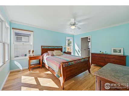 a spacious bedroom with a bed and a night stand