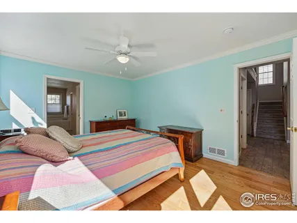 a bedroom with a bed and a painting on the wall