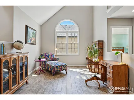 a kitchen with stainless steel appliances kitchen island granite countertop a table chairs and a refrigerator