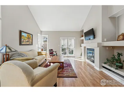 a view of a dining room with furniture and a chandelier