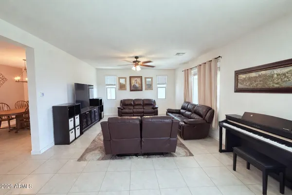 a living room with furniture and a piano