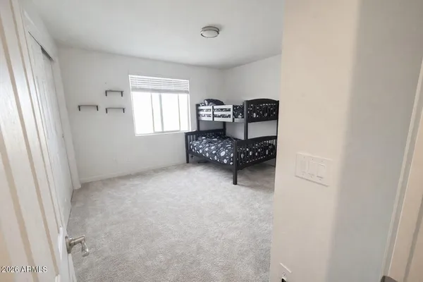 a bedroom with a bed and a window