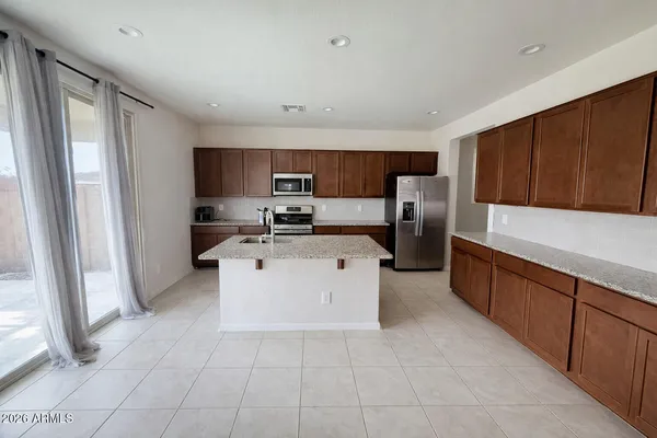 a kitchen with stainless steel appliances granite countertop a refrigerator sink and cabinets