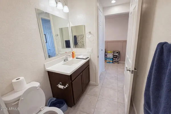 a bathroom with a sink mirror and toilet
