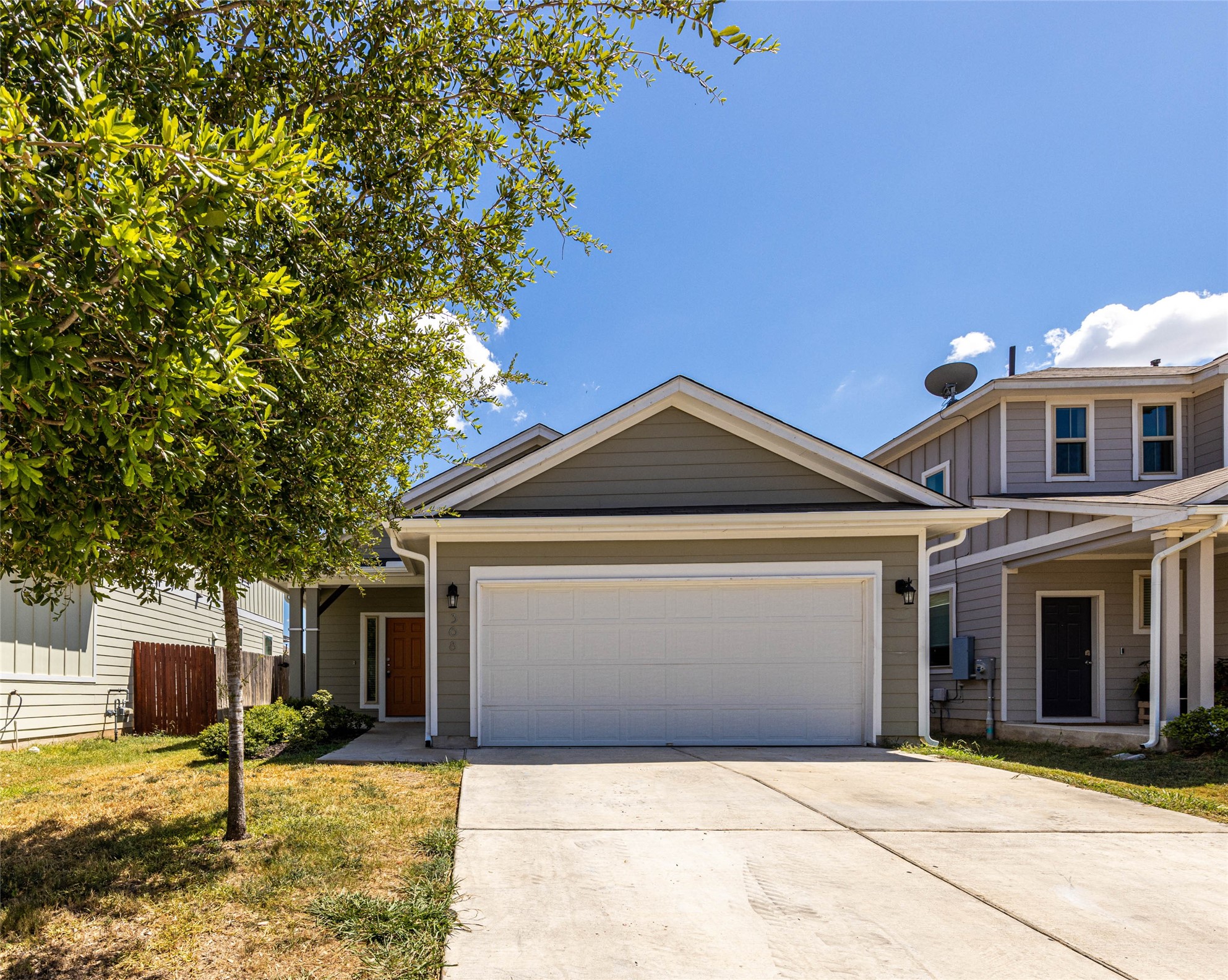 Contemporary single-story residence featuring siding exterior, an attached two-car garage, and a concrete driveway