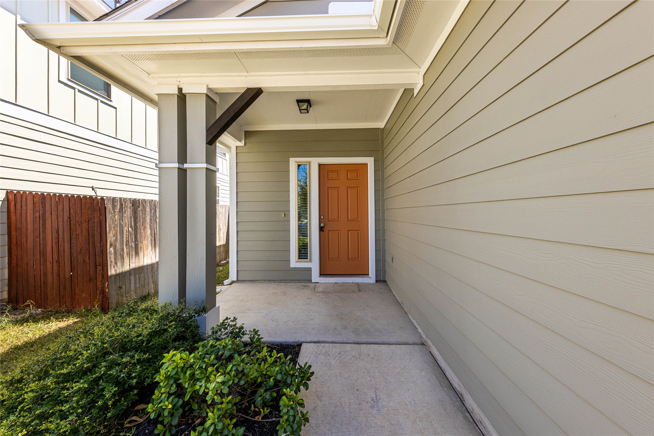 368 Wapiti Road Buda, TX 78610 - Photo 2 of 20 Covered front entry featuring a paneled front door, sidelight, and exterior lighting fixture