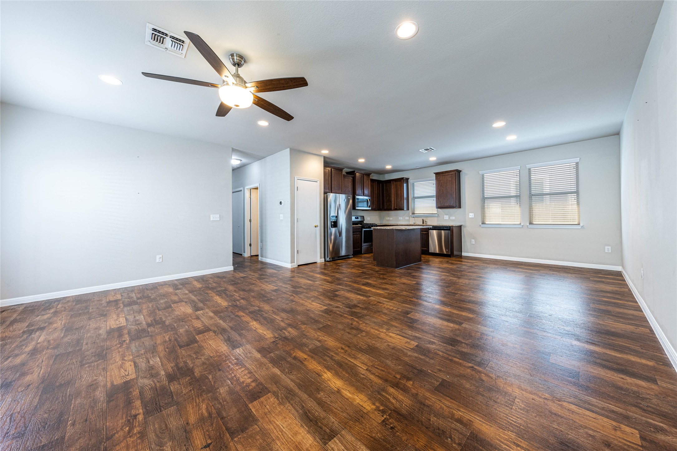 368 Wapiti Road Buda, TX 78610 - Photo 3 of 20 Open-concept living space featuring wood-finish flooring, recessed lighting, and a ceiling fan