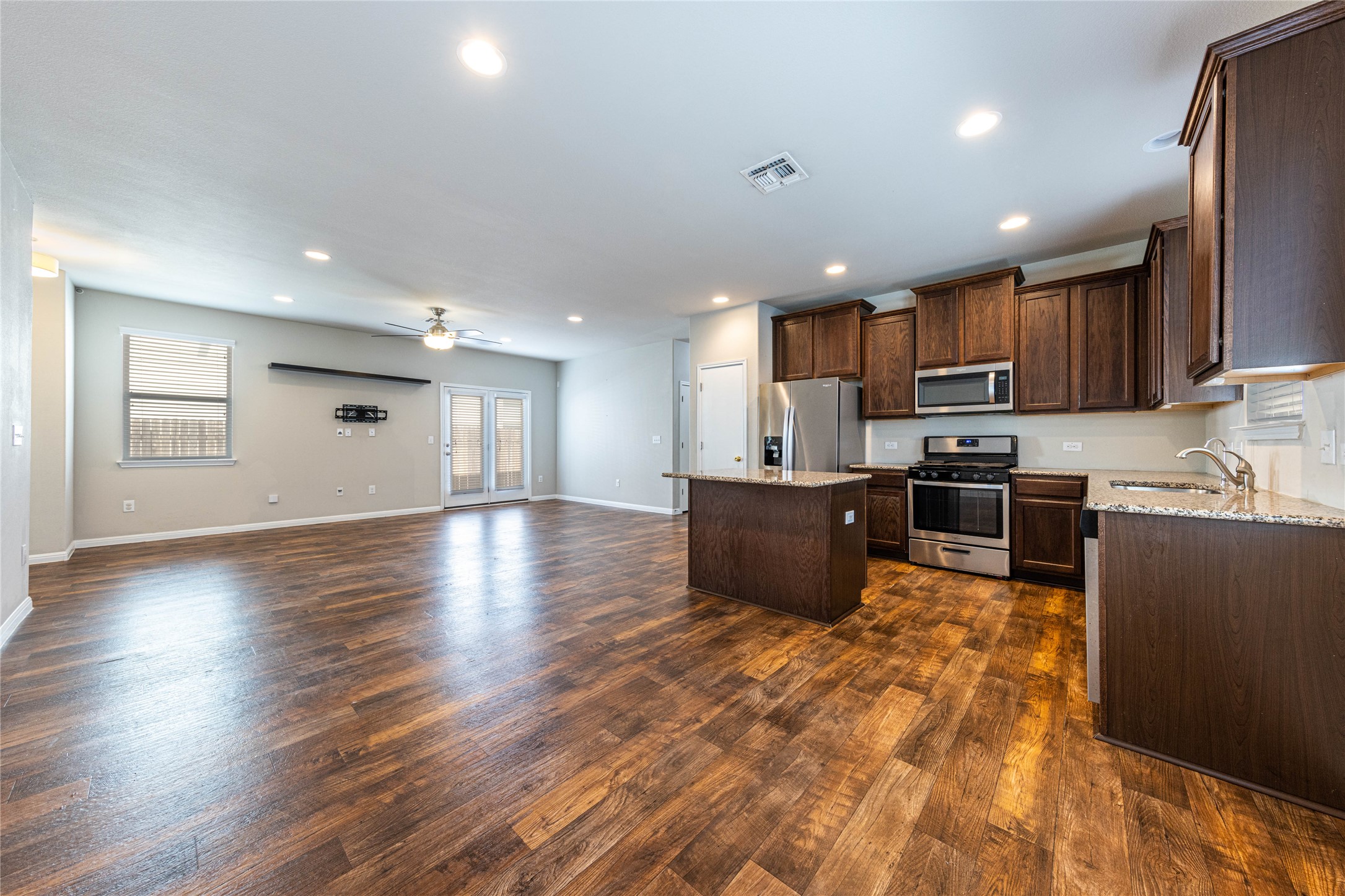 368 Wapiti Road Buda, TX 78610 - Photo 5 of 20 Open-concept living space featuring wood-finish flooring, recessed lighting, and a ceiling fan