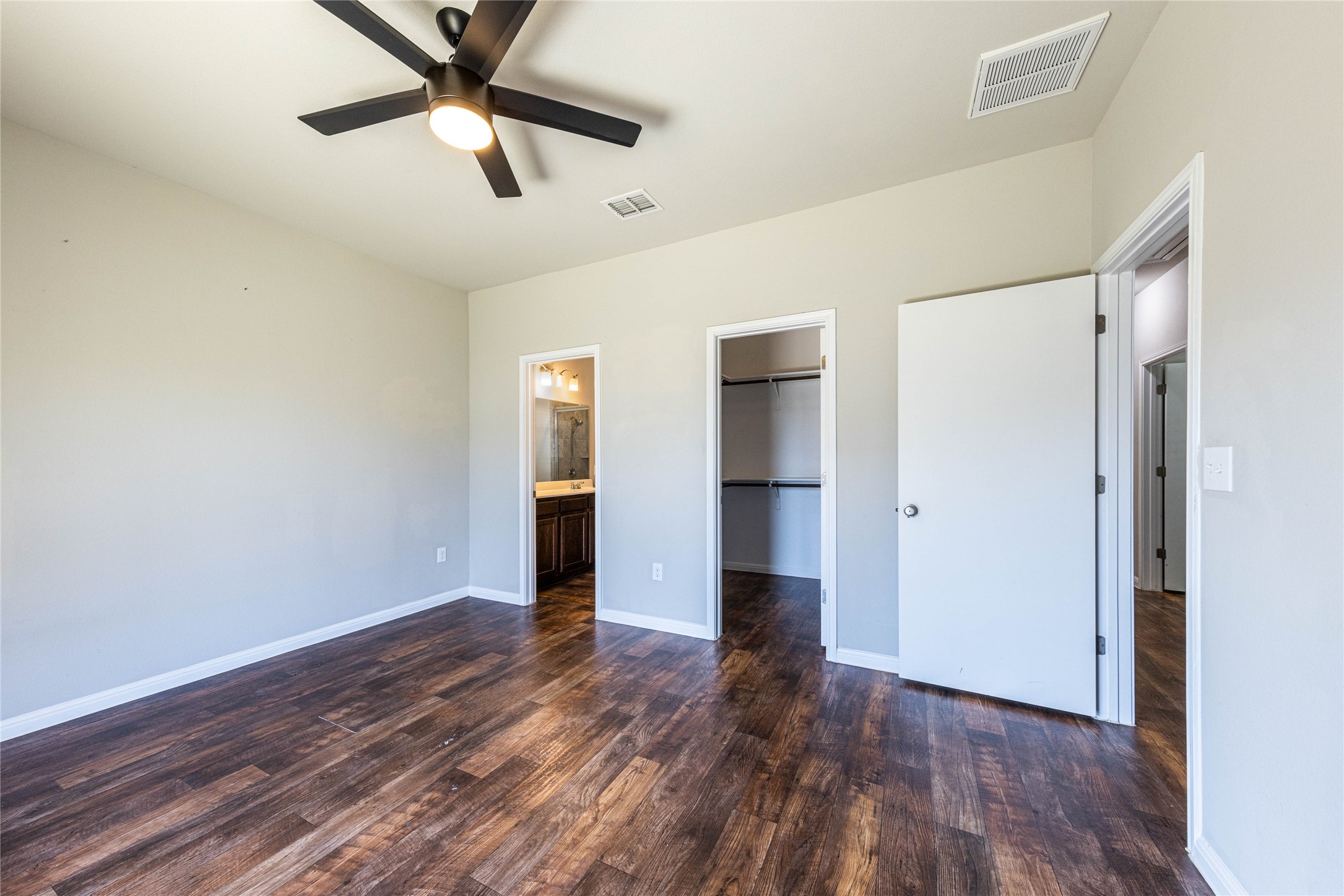 368 Wapiti Road Buda, TX 78610 - Photo 9 of 20 Spacious room featuring wood-finish flooring, light neutral wall tones, and a ceiling fan with integrated lighting
