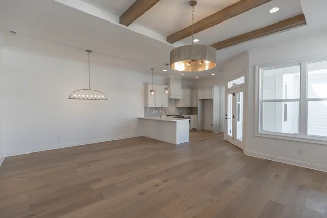 a view of a kitchen with a dishwasher cabinets and a large window