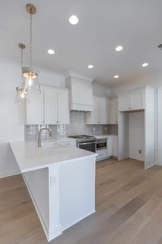 a large kitchen with kitchen island a sink stainless steel appliances and cabinets