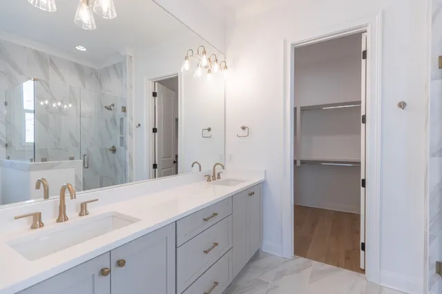 a bathroom with a double vanity sink and a mirror