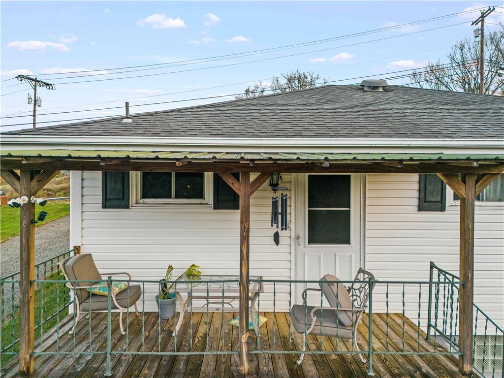 35 Lagonda Road Washington, PA 15301 - Photo 27 of 34 a view of a patio with table and chairs with wooden floor and fence