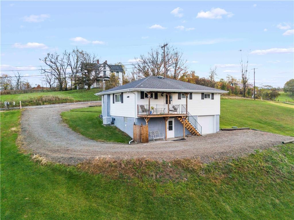 35 Lagonda Road Washington, PA 15301 - Photo 3 of 34 a view of a house next to a big yard with large trees
