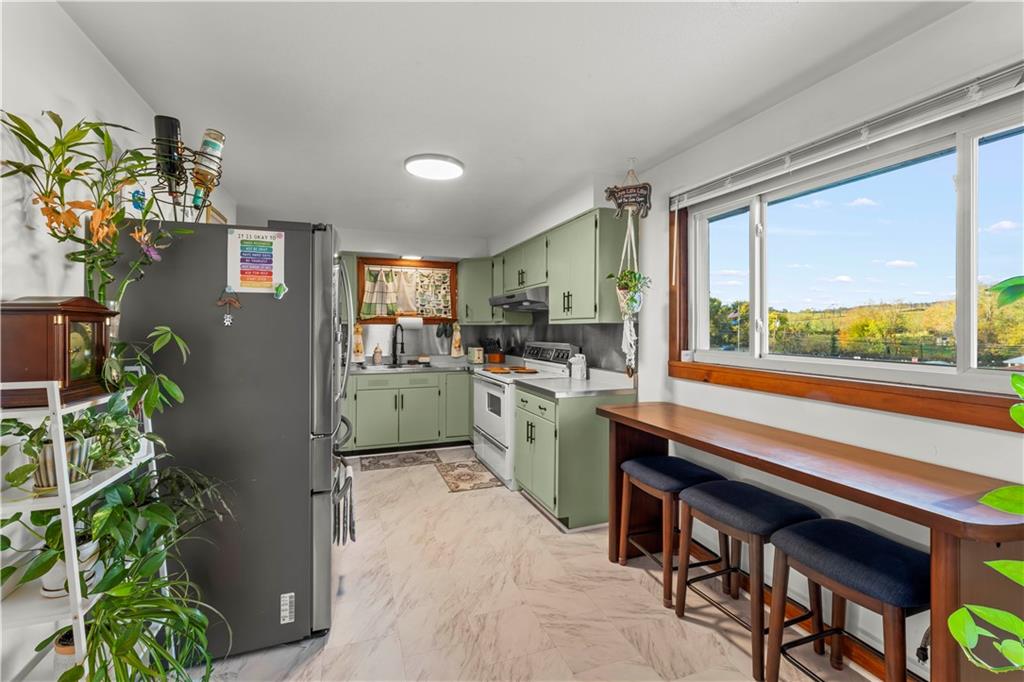 35 Lagonda Road Washington, PA 15301 - Photo 9 of 34 a kitchen with appliances cabinets and a potted plant