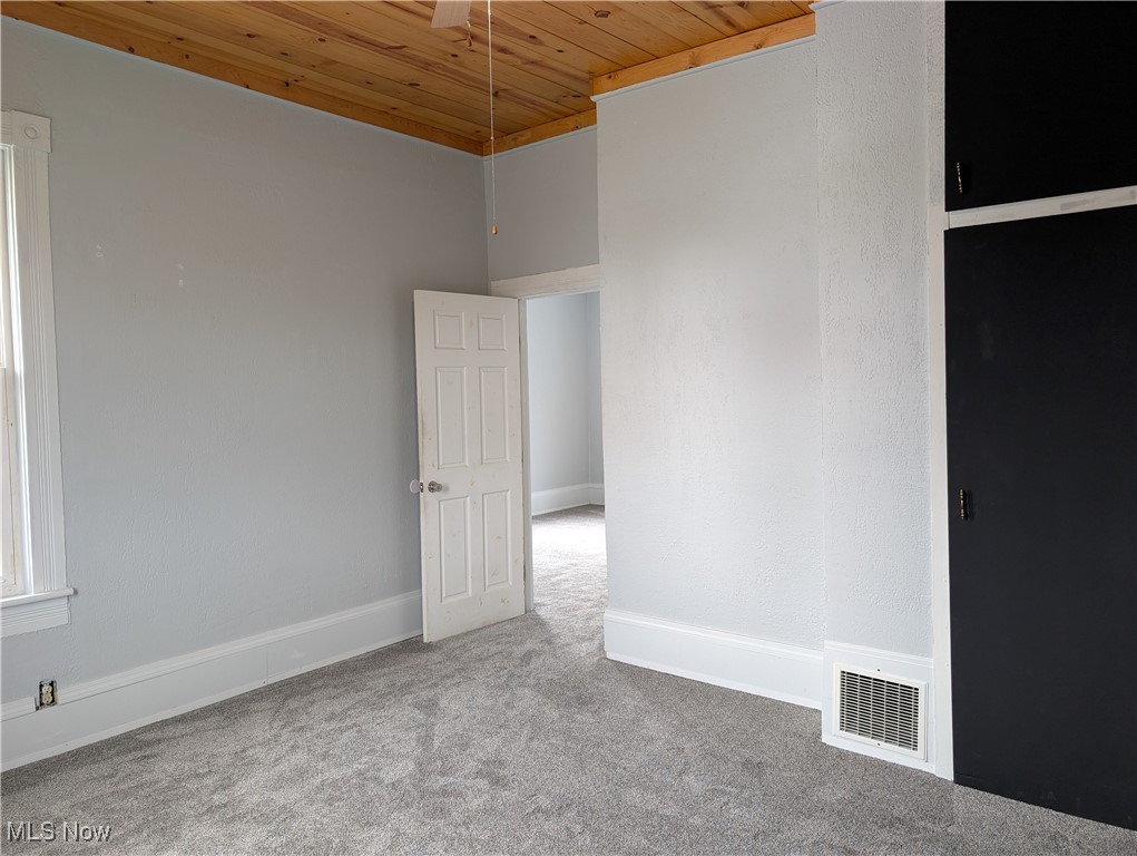 10143 Pleasant Road Pleasant City, OH 43772 - Photo 14 of 32 Carpeted empty room with wooden ceiling and baseboards