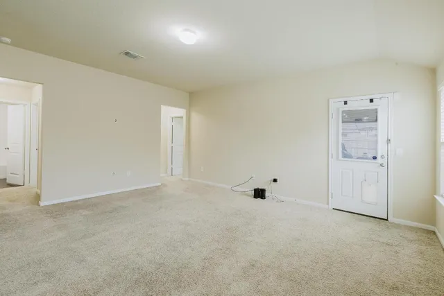 an empty room with white wall and closet