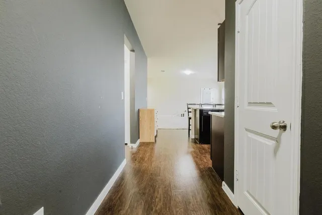 a view of a kitchen from a hallway