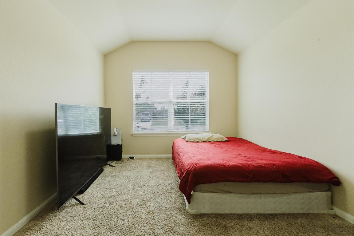 184 Voss Kyle, TX 78640 - Photo 7 of 30 a bedroom with a bed and a window