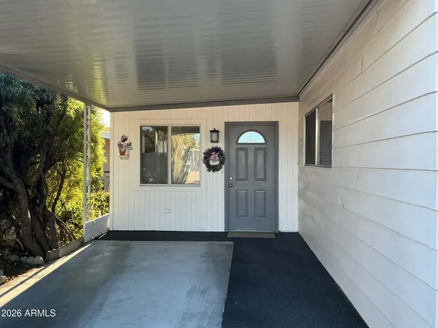a view of a porch with wooden floor and a floor to ceiling window