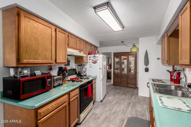 a kitchen with stainless steel appliances granite countertop a stove sink and cabinets