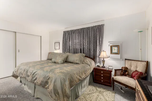 a bedroom with a bed and a couch