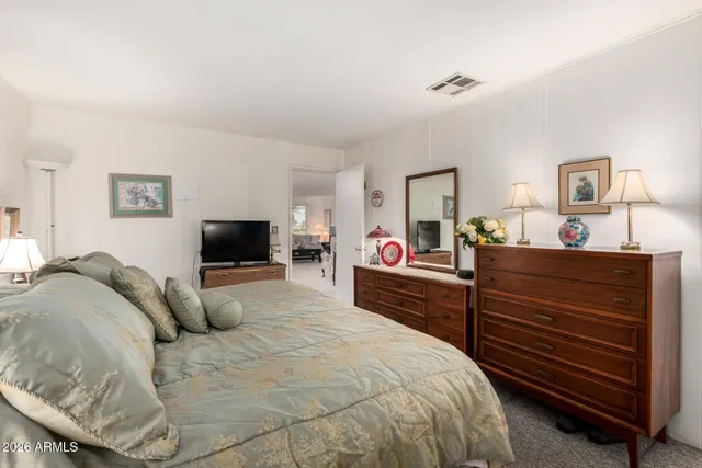 a bedroom with a bed and a flat screen tv