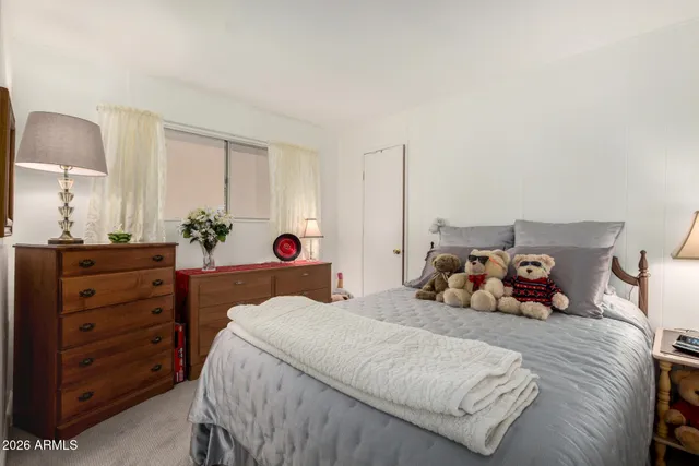 a bedroom with a bed and a dresser