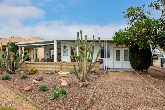 a view of a house with backyard and a tree