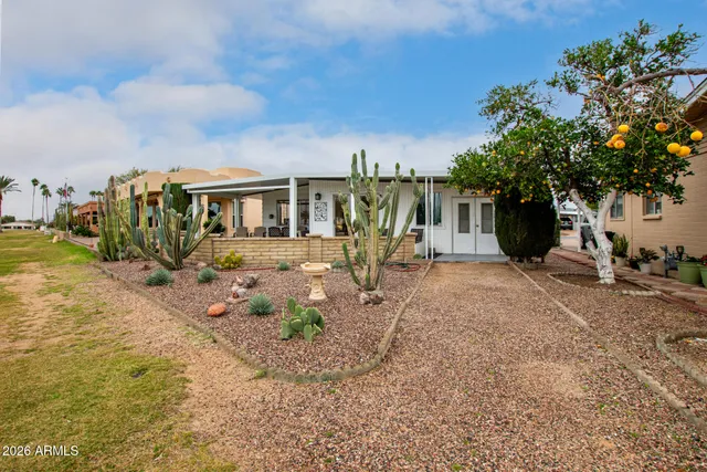 a view of a house with backyard and sitting area