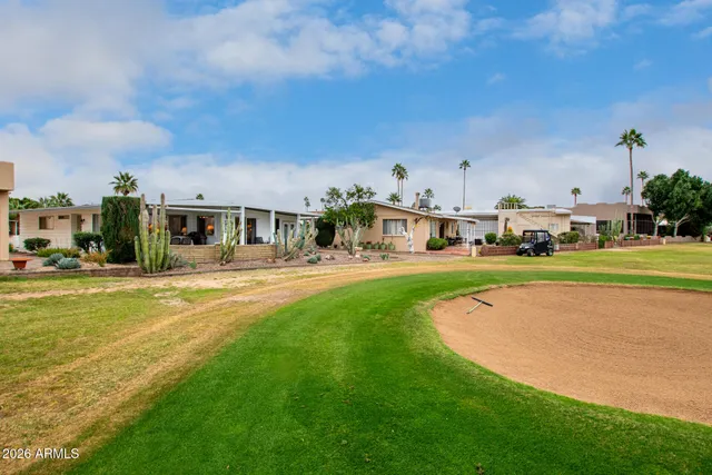 a view of building with outdoor space and swimming pool