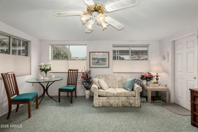 a living room with furniture and chandelier