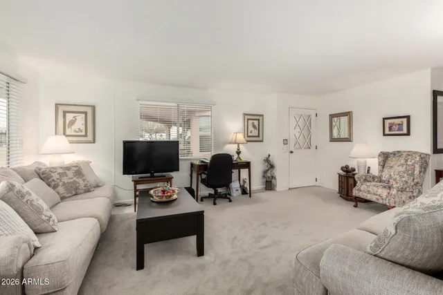 a living room with furniture a couch and a flat screen tv