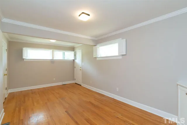 wooden floor in an empty room with a window