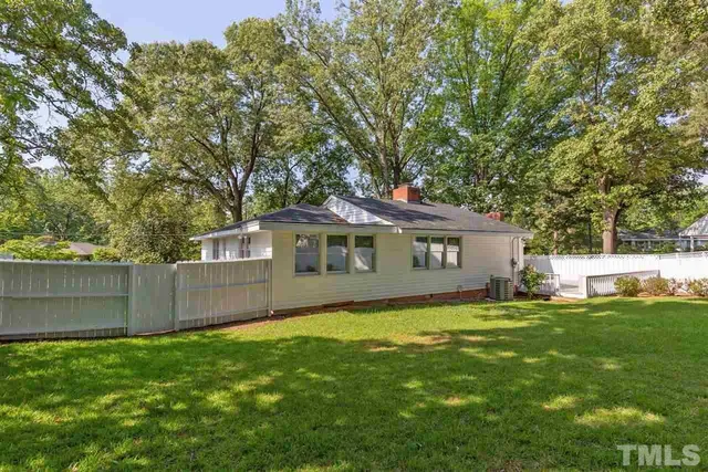 a view of yard with swimming pool and trees