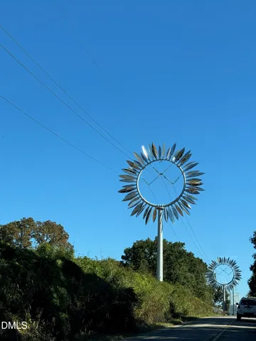 a sign broad in front of flowers