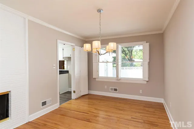 a view of a kitchen with a window and wooden floor