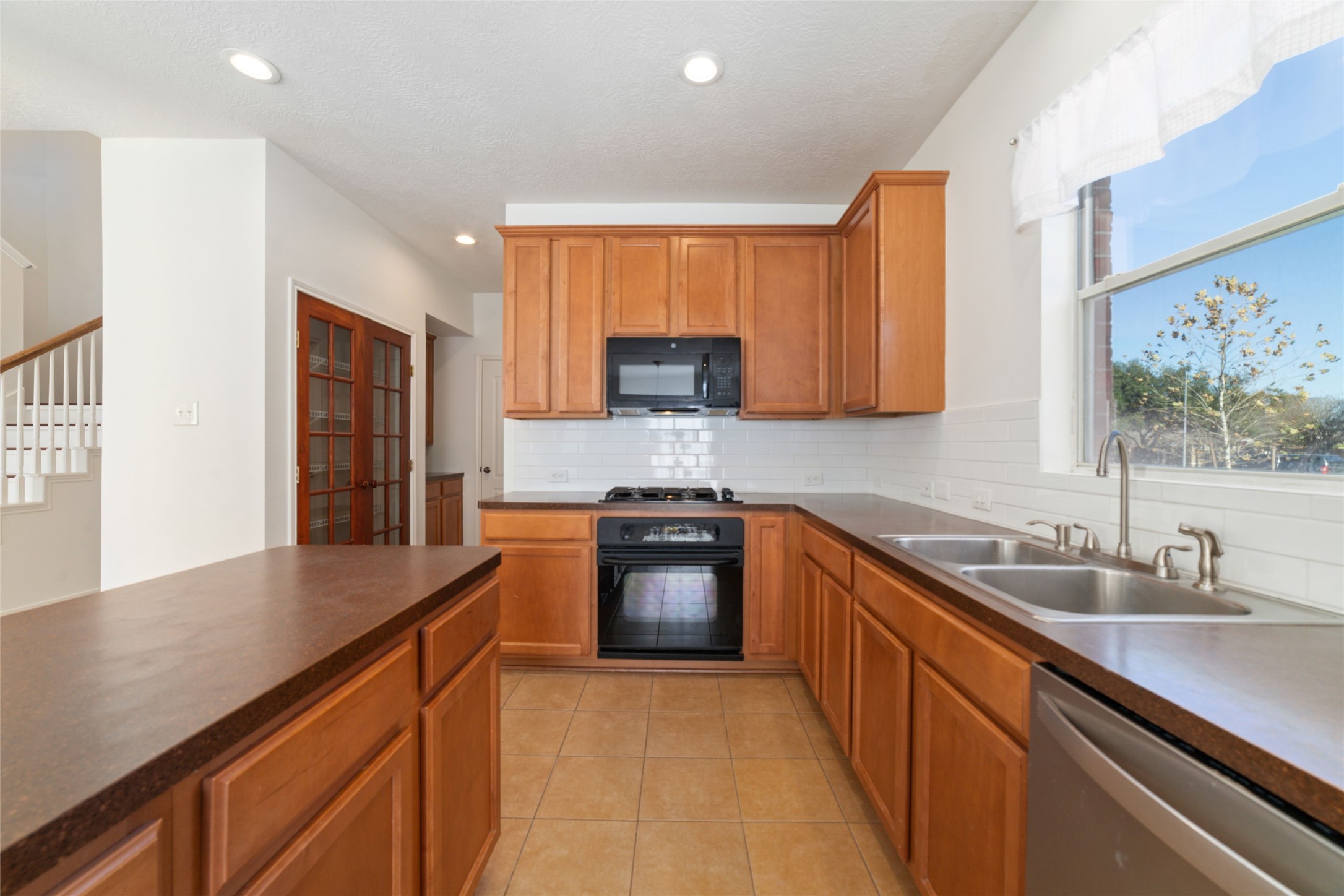2618 Bridgestone Park Lane Spring, TX 77386 - Photo 16 of 49 Tile floors and durable formica countertops make cleaning and maintaining this kitchen a breeze.